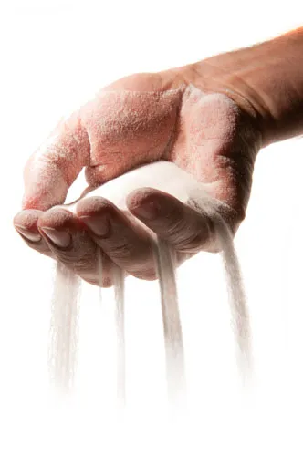 Hand with powdered ingredient for culture media